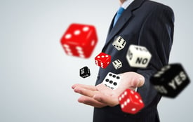 Close up of businessman throwing dice. Gambling concept